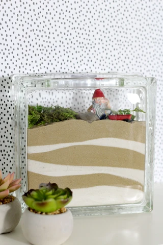 An indoor fairy garden is a fantastic project to make with kids or adults!  Use Scenic Sand to create a beautiful layered look.